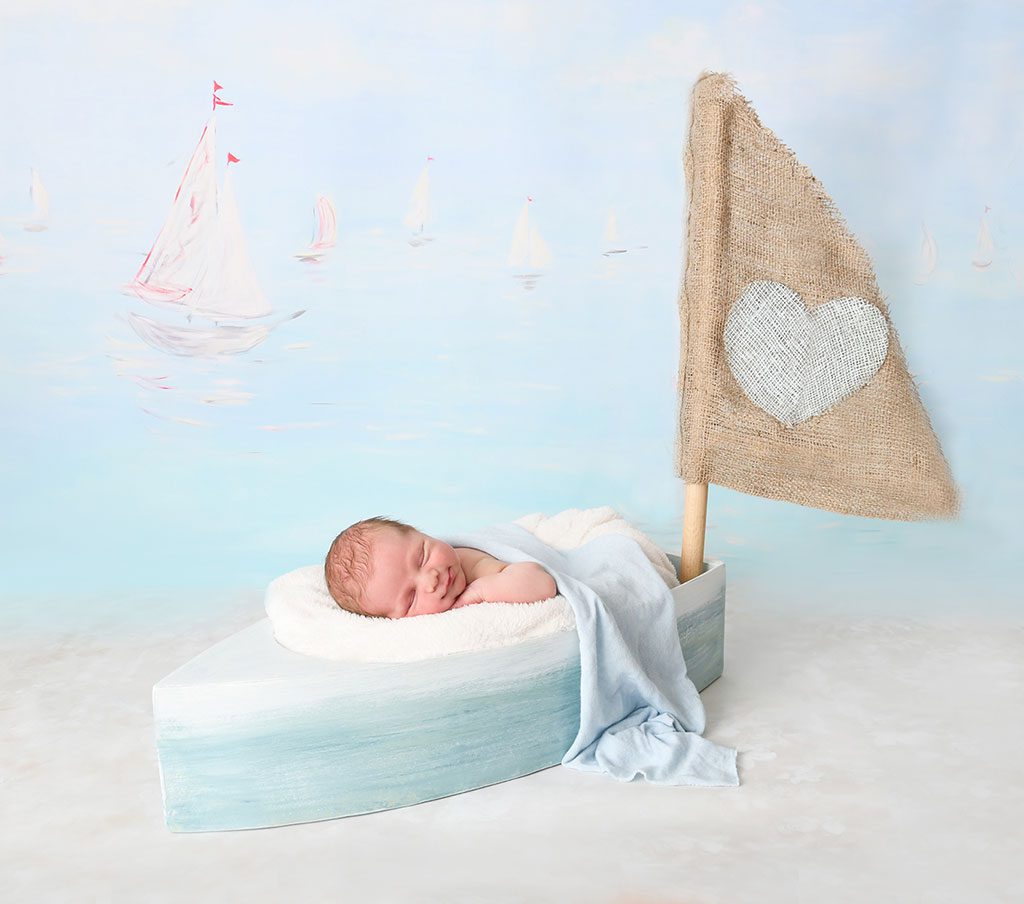 Smiling Sleeping Baby Portrait in a Boat